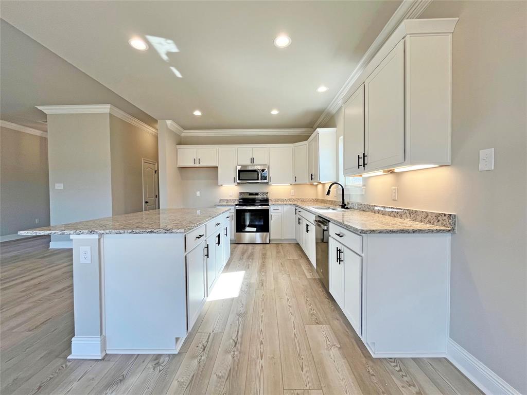 369 Hummingbird Lane Princeton, LA 71067 - Photo 8 of 22 a kitchen with stainless steel appliances granite countertop a lot of cabinets and wooden floor