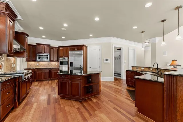 a view of a dining room with furniture wooden floor and chandelier