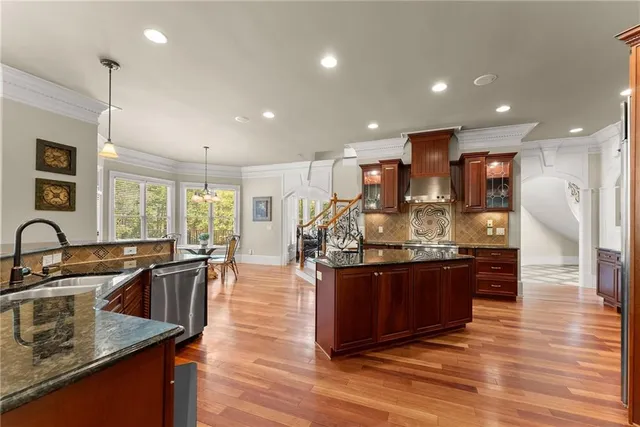 a living room with furniture a fireplace and a chandelier