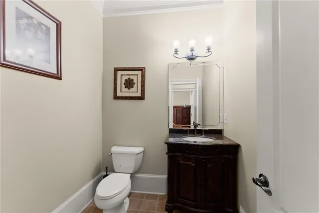 a spacious bedroom with a bed a chandelier and windows