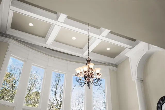 a view of a dining room with furniture and chandelier
