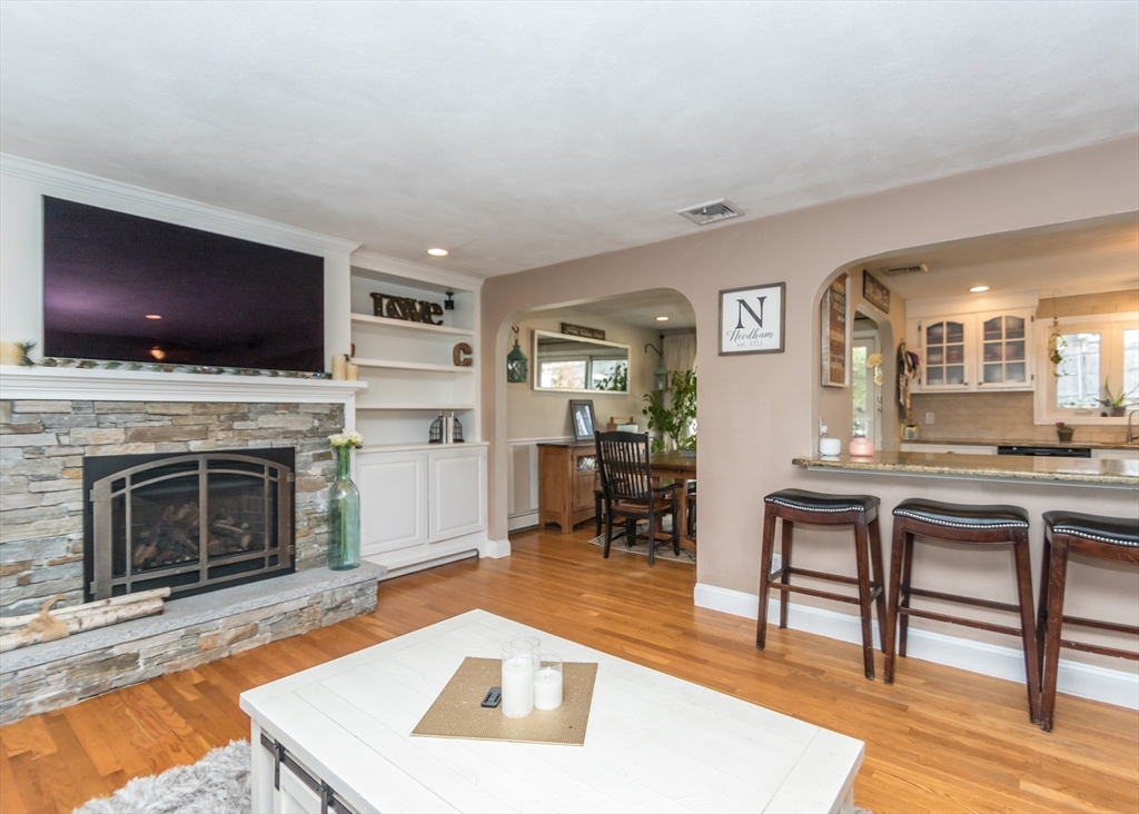27 Sherman Street Needham, MA 02494 - Photo 5 of 32 a living room with furniture a flat screen tv and a fireplace