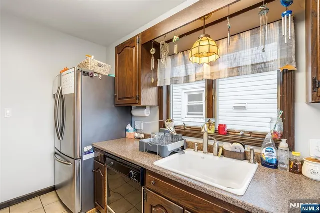 a kitchen with a sink and a refrigerator