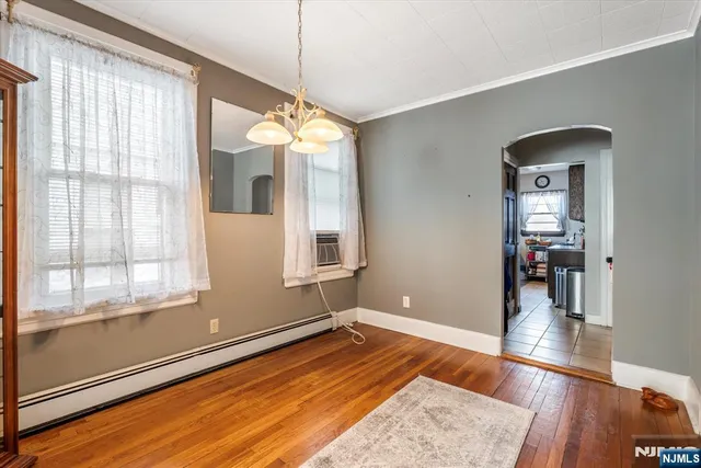 a view of a room with wooden floor and window