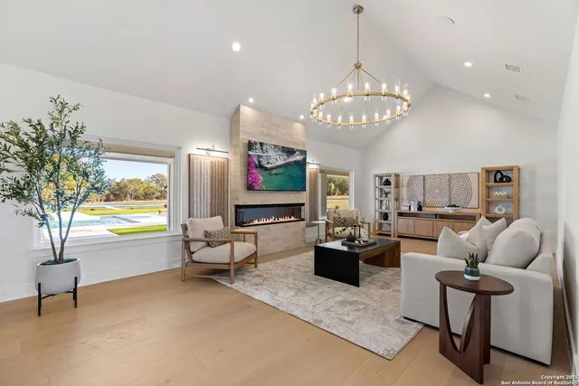 a kitchen with kitchen island granite countertop a sink and a refrigerator