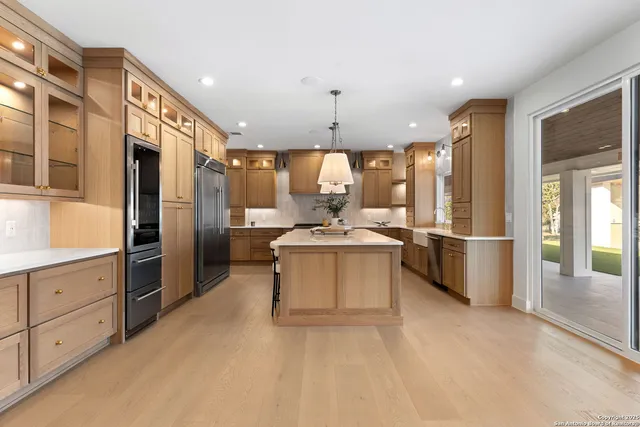 a kitchen with lots of counter space and windows