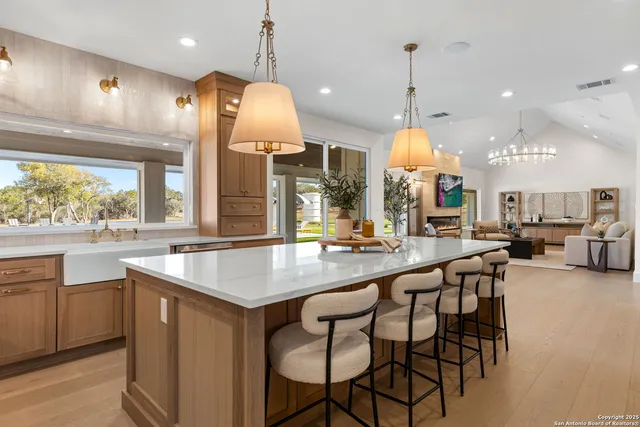 a spacious bedroom with furniture and a chandelier