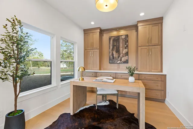 a spacious bedroom with a bed chandelier and a window