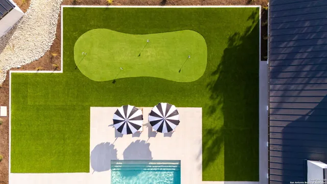 a living room with furniture a fireplace and a chandelier