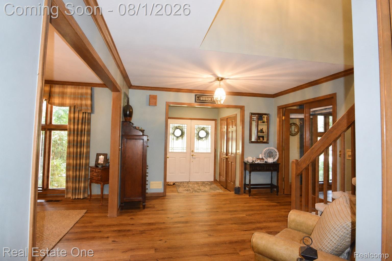 1370 Springwood Lane Rochester, MI 48309 - Photo 12 of 37 Entry foyer featuring wood-finish flooring, a double-door entry with sidelights, and a wood staircase