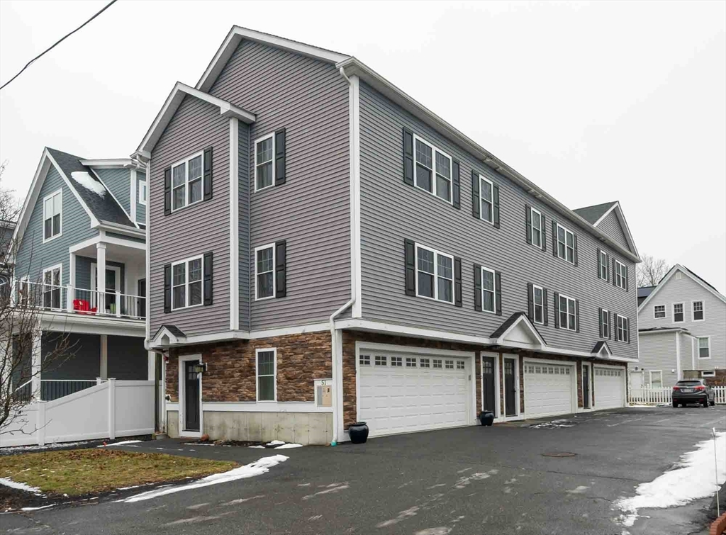 51 Branch Street, Unit 2 Quincy, MA 02169 - Photo 1 of 37 a front view of a building with a road