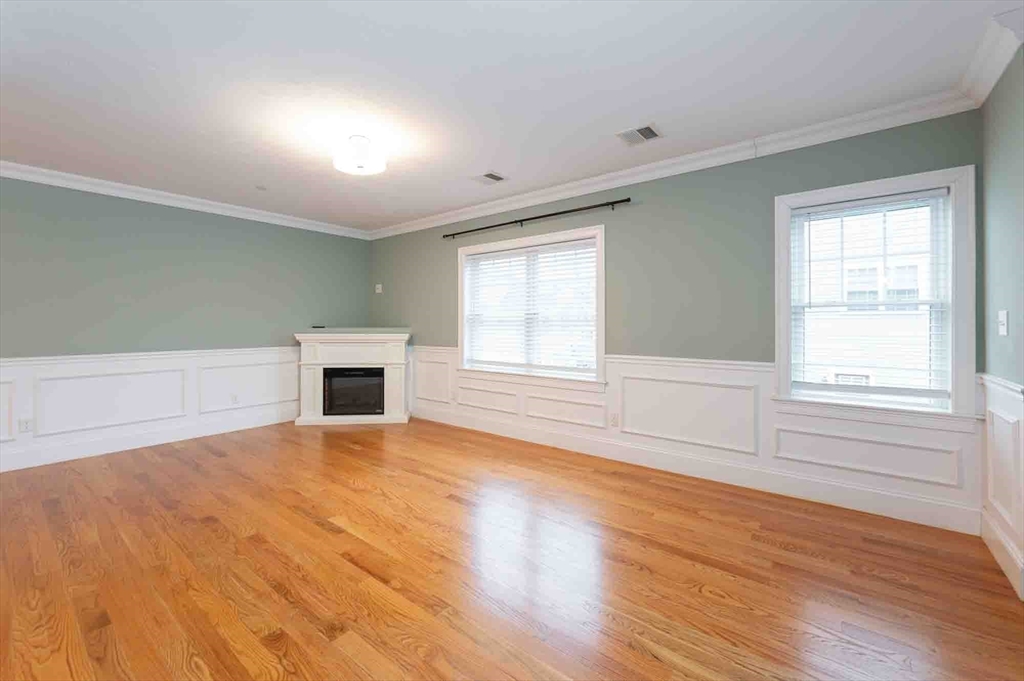 51 Branch Street, Unit 2 Quincy, MA 02169 - Photo 13 of 37 a view of empty room with wooden floor and fan