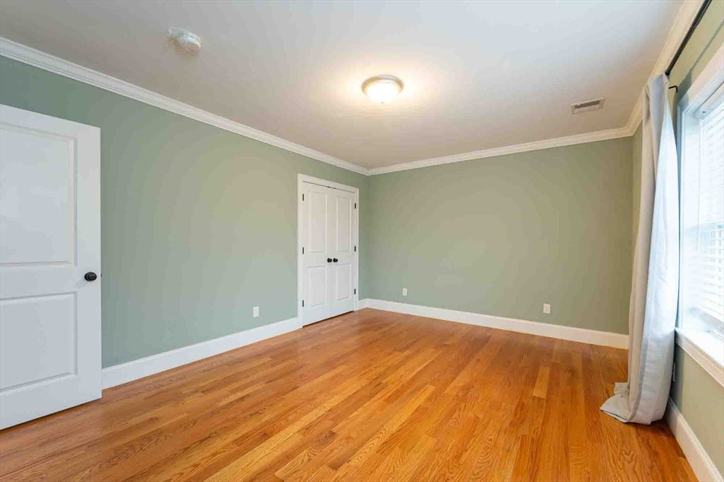 51 Branch Street, Unit 2 Quincy, MA 02169 - Photo 25 of 37 a view of empty room with wooden floor