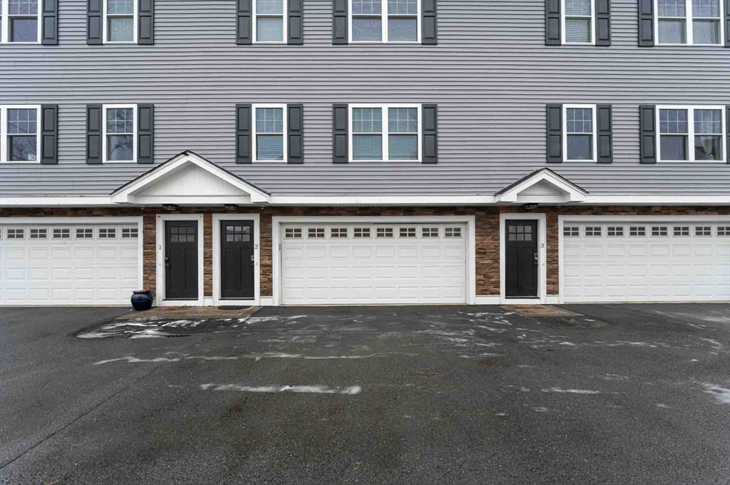 51 Branch Street, Unit 2 Quincy, MA 02169 - Photo 5 of 37 a front view of a house with yard and parking space