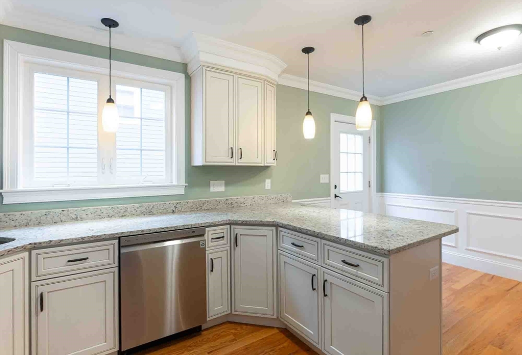 51 Branch Street, Unit 2 Quincy, MA 02169 - Photo 9 of 37 a kitchen with stainless steel appliances granite countertop a sink a window and appliances