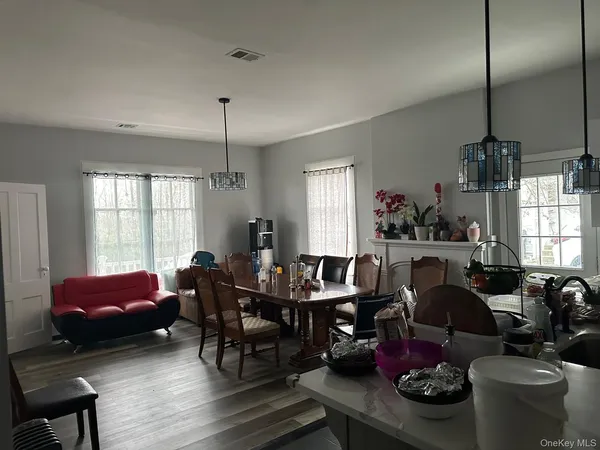 a living room with furniture a fireplace and a window