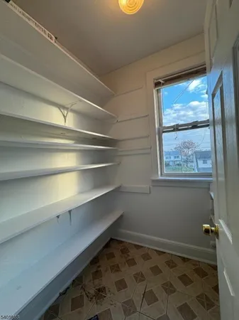 a view of room with window and wooden floor