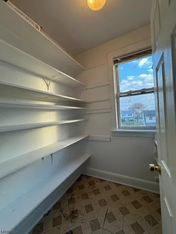 a view of room with window and wooden floor