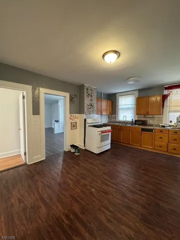 a view of a kitchen with refrigerator stove microwave and cabinets