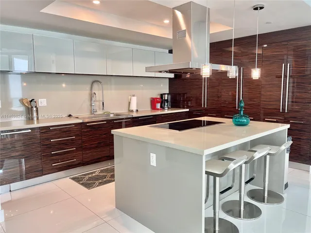 a kitchen with a sink a stove and cabinets