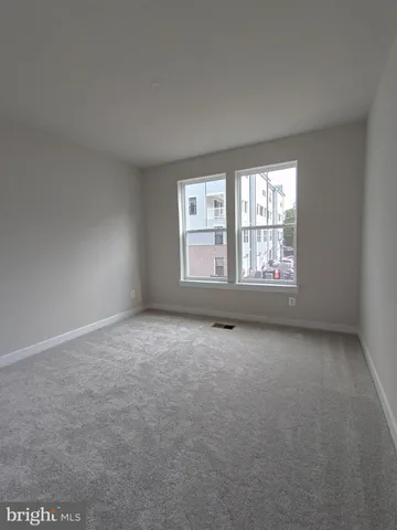 a view of an empty room and closet area