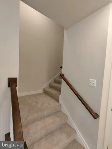 a view of staircase with rug