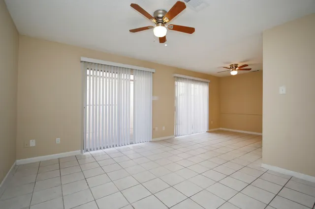 an empty room with closet and windows