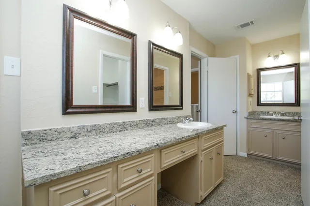an empty room with closet and a ceiling fan