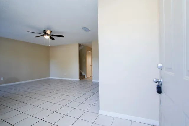 a view of an empty room with a ceiling fan