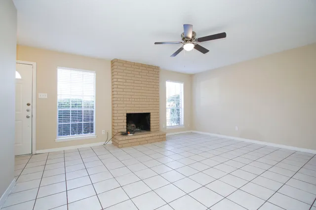 a view of an empty room with a fireplace