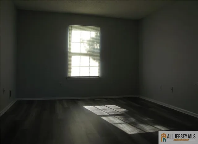a view of wooden floor and windows in a room
