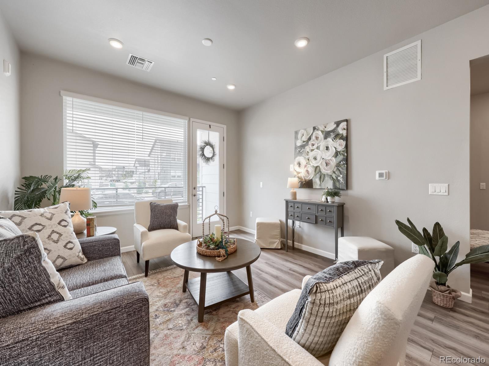 6153 North Ceylon Street, Unit 10108 Denver, CO 80249 - Photo 2 of 11 a living room with furniture and a large window