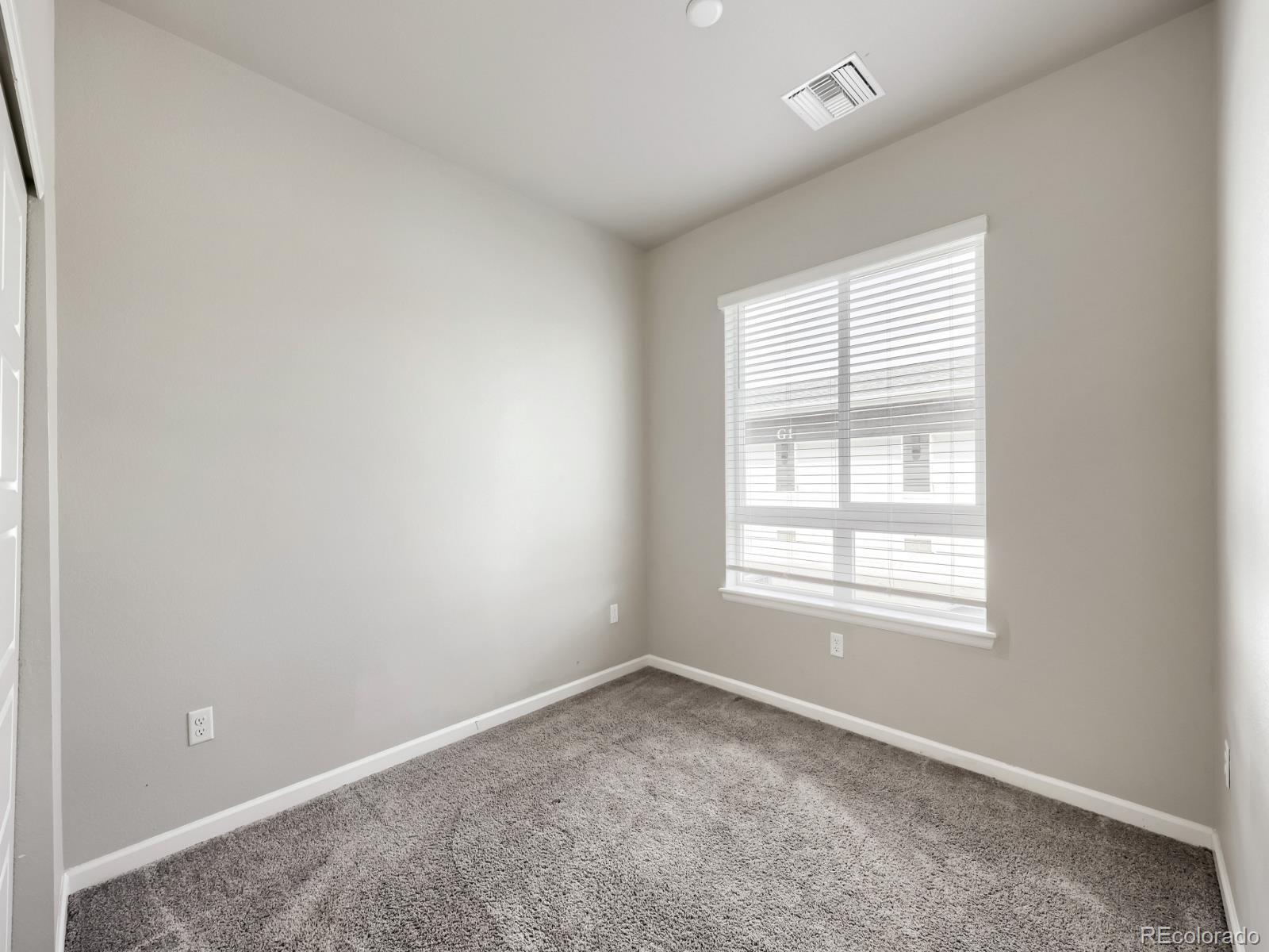 6153 North Ceylon Street, Unit 10108 Denver, CO 80249 - Photo 8 of 11 an empty room with a window
