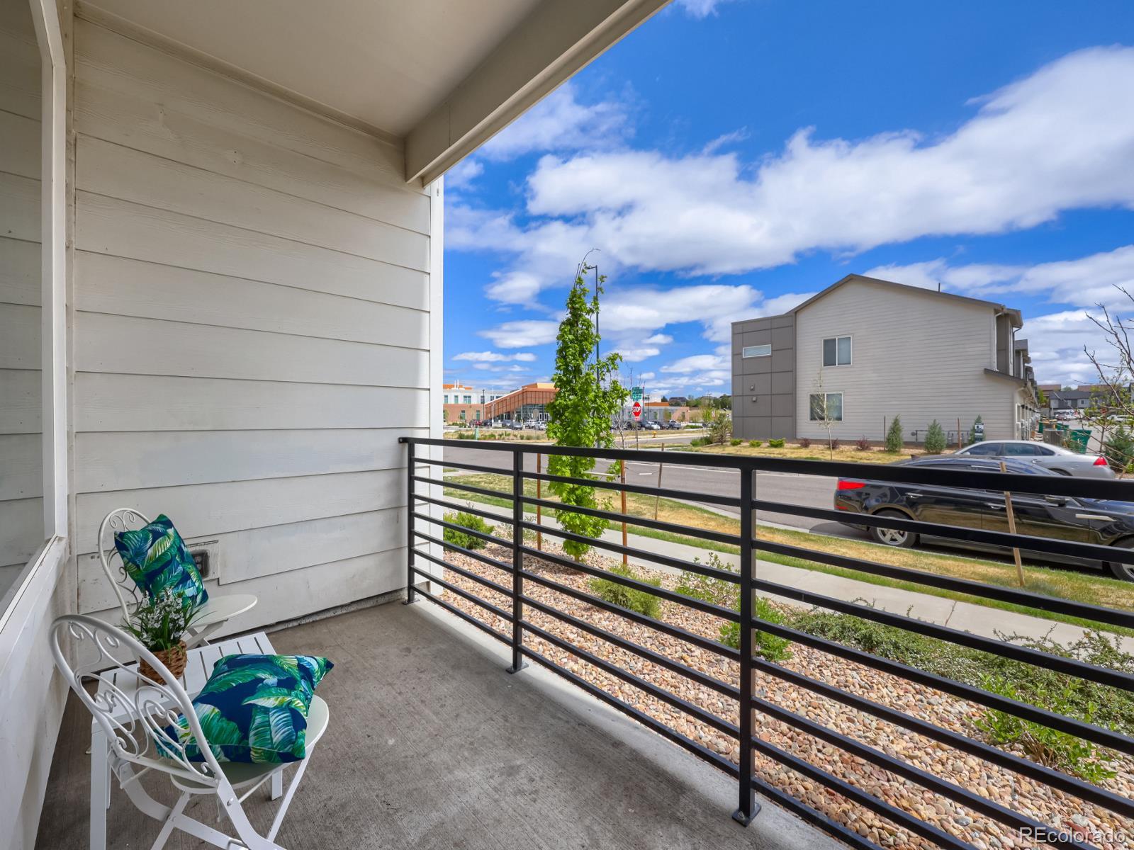 6153 North Ceylon Street, Unit 10108 Denver, CO 80249 - Photo 9 of 11 a view of a porch with a bench