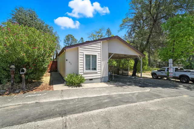 a view of a house with a yard and garage