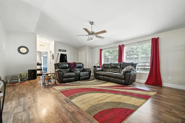 a living room with furniture rug and window