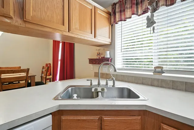 a kitchen with stainless steel appliances a sink and a window