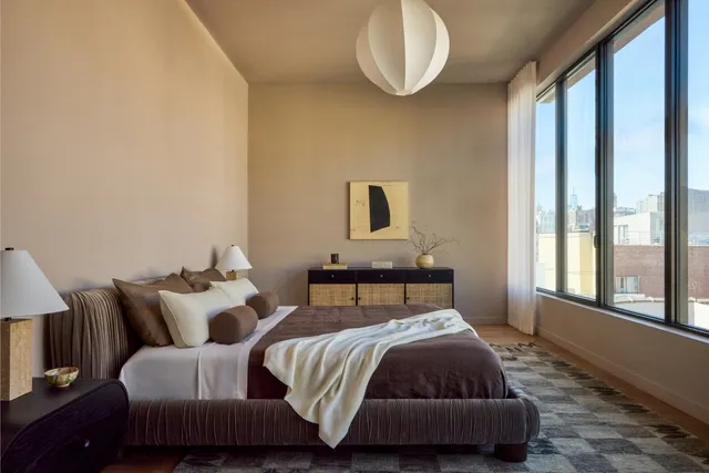 a bedroom with bed and window