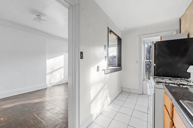 a view of a kitchen with microwave and furniture