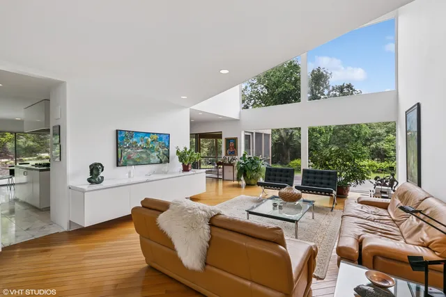a living room with fireplace furniture and a large window