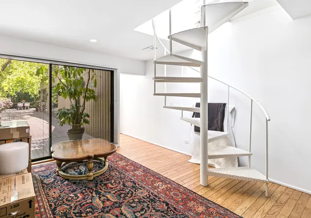 a bedroom with a bed lamp and a window