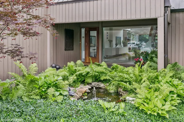 an aerial view of residential house with outdoor space and swimming pool