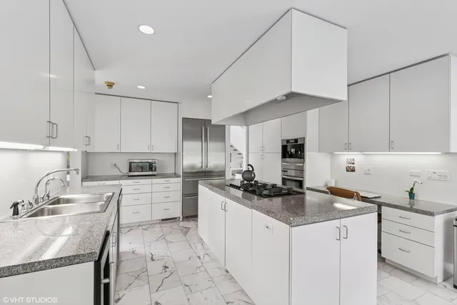 a living room with fireplace furniture and a large window