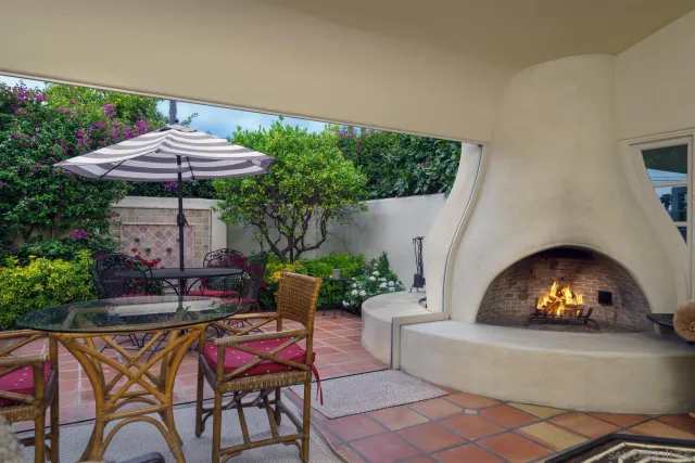 a view of a patio with a table and chairs under an umbrella