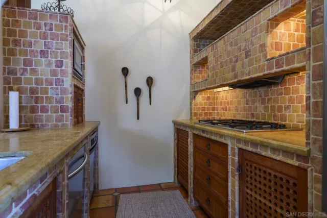a kitchen with a stove and a sink