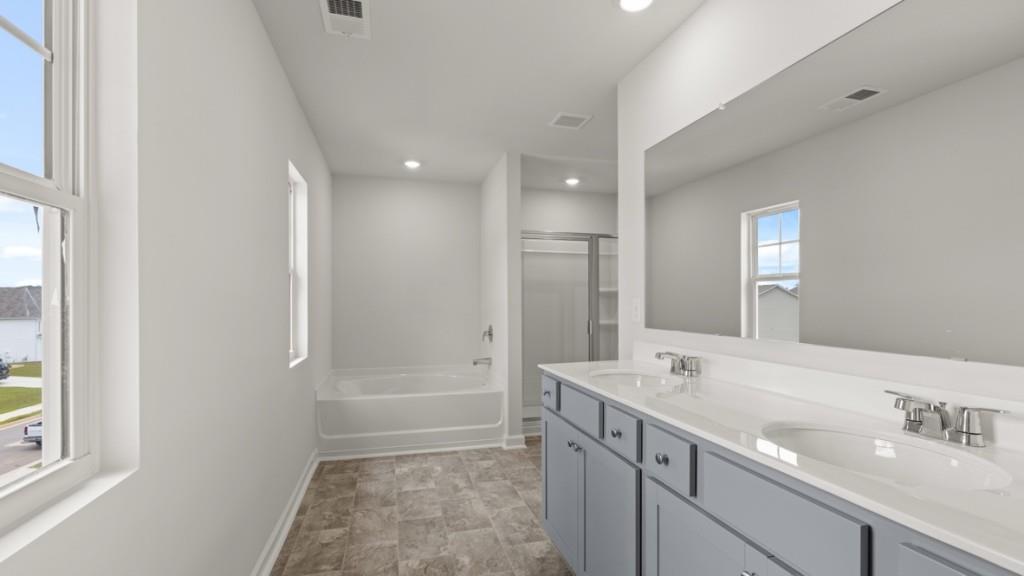 174 Thompson Ridge Lane Dallas, GA 30132 - Photo 20 of 35 a bathroom with a shower sink and mirror