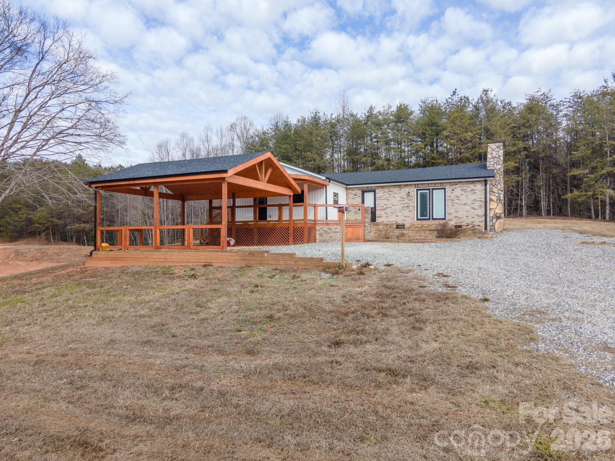 7400 Corn Hill Road Connelly Springs, NC 28612 - Photo 2 of 41 a front view of a house with a garden