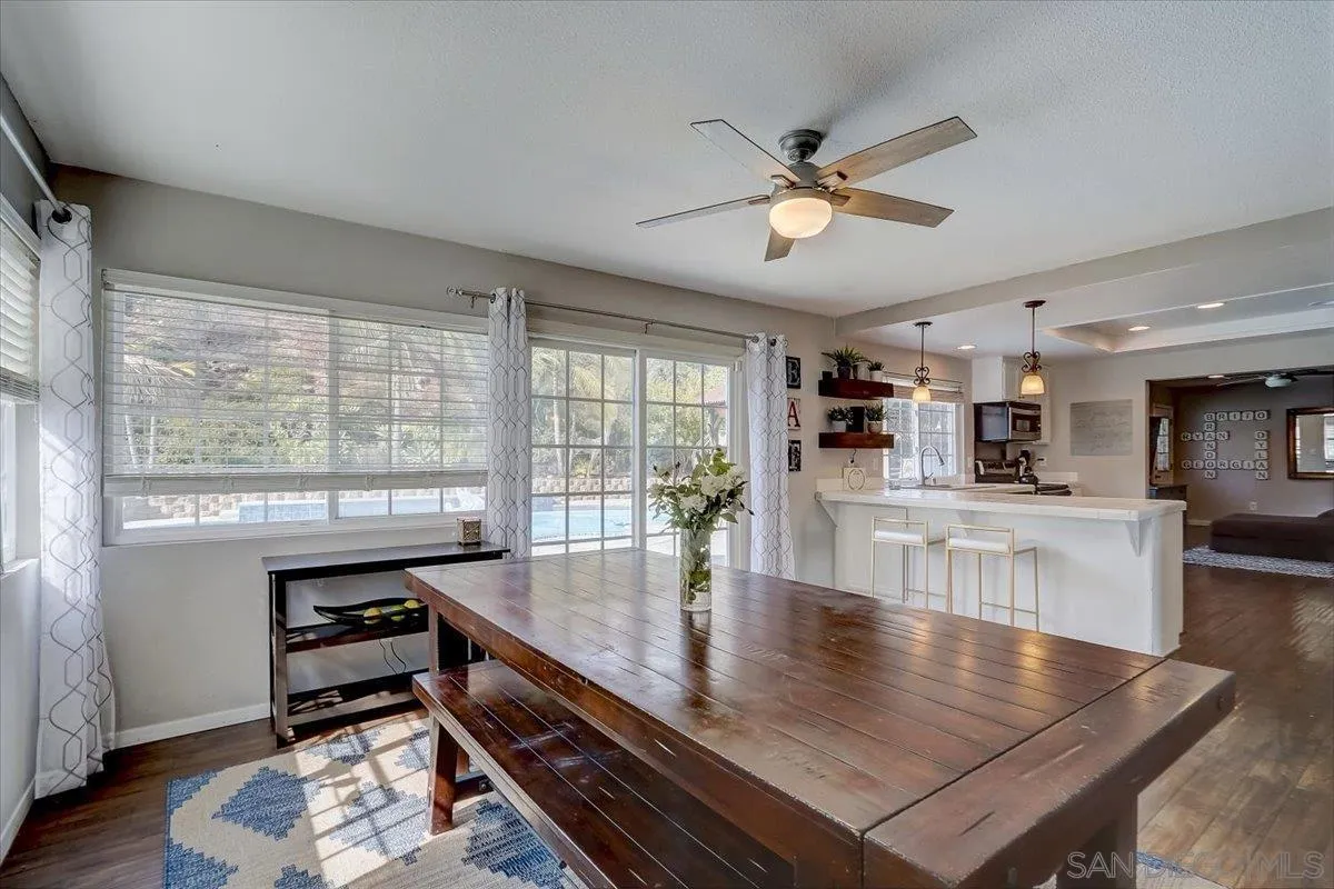4094 Tambor Road San Diego, CA 92124 - Photo 14 of 49 a view of a dining room with furniture window and wooden floor