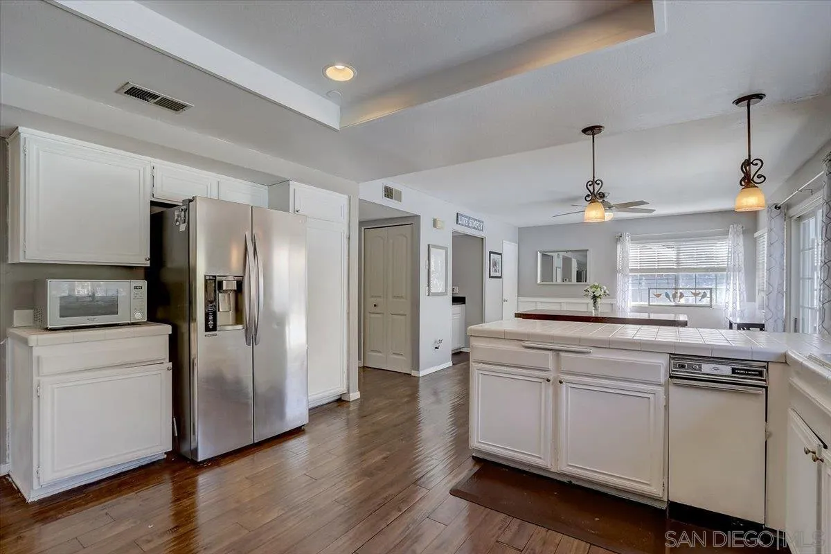 4094 Tambor Road San Diego, CA 92124 - Photo 19 of 49 a kitchen with stainless steel appliances a refrigerator sink and microwave