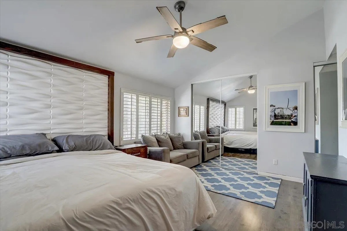 4094 Tambor Road San Diego, CA 92124 - Photo 27 of 49 a bedroom with a bed a couch and a window